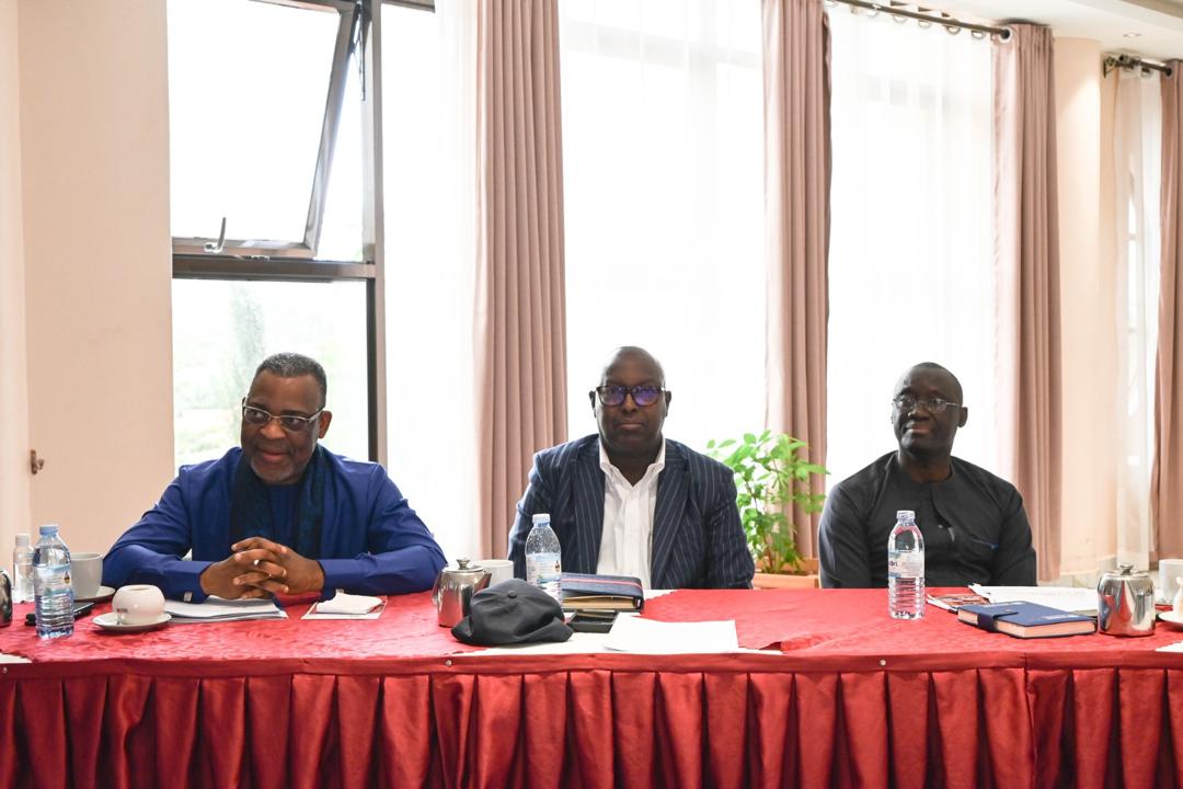 Dr. Gassama seated with fellow panelists at a strategic planning session