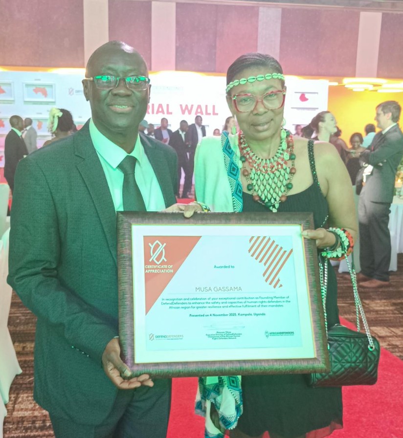 Dr. Musa Gassama receiving the Certificate of Appreciation as Founding Member of DefendDefenders