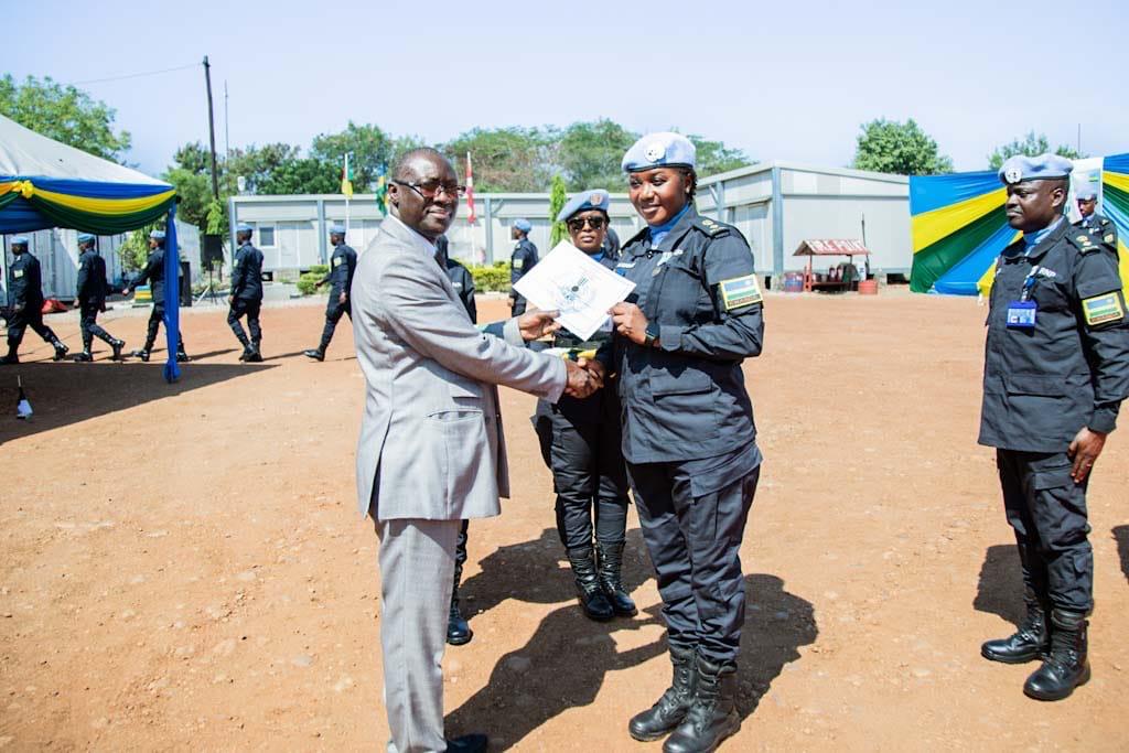 Dr. Gassama presenting a UN medal and certificate to a Rwanda FPU officer